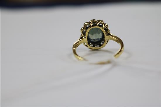 An 18ct gold, diamond and pale blue/green zircon set oval cluster ring, size P.
